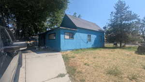 View of side of property with a yard