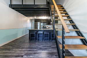 Stairs with wood finished floors and baseboards