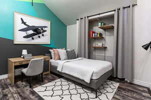 Bedroom with vaulted ceiling, an office area, and dark wood-style flooring