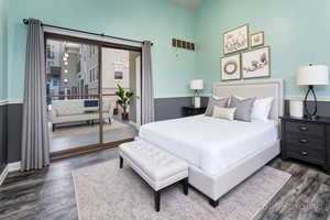 Bedroom featuring dark wood-style flooring and access to outside