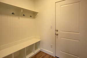 Mudroom with dark wood-style floors and baseboards