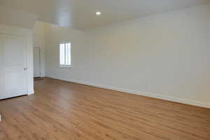 Spare room featuring light wood finished floors and recessed lighting