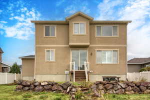 Rear view of property with stucco siding