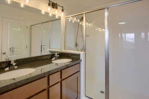 Master Bathroom featuring double vanity and a stall shower