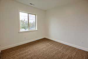 Carpeted bedroom #1 with baseboards