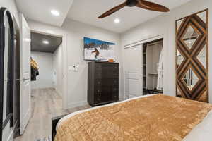Bedroom featuring wood finished floors, a closet, recessed lighting, and a ceiling fan