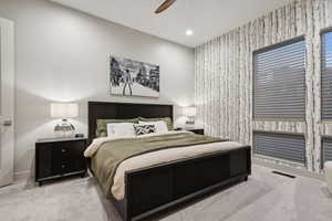Carpeted bedroom featuring ceiling fan and recessed lighting