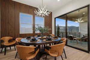 Dining room featuring a chandelier, light wood-style floors, a mountain view, plenty of natural light, and recessed lighting