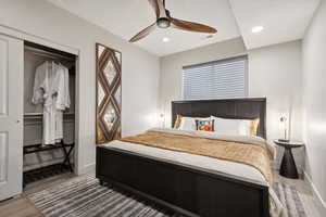 Bedroom featuring wood finished floors, ceiling fan, recessed lighting, and a closet
