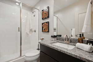 Bathroom with vanity and a stall shower