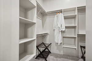 Walk in closet with light carpet
