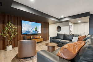 Cinema with wood finished floors, recessed lighting, and wood walls