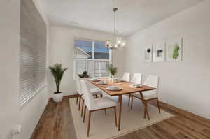 Dining space with light wood-style floors and a chandelier