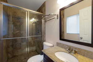 Full bathroom featuring vanity and a shower stall