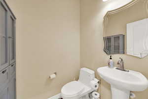 Half bathroom with toilet and a sink