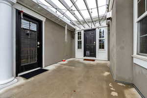 Entrance to property with a patio and stucco siding