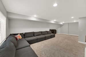 Living area with carpet floors and recessed lighting