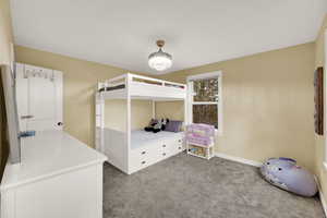 Bedroom with carpet floors and a chandelier