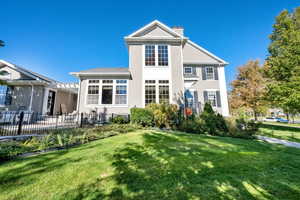 Rear view of property featuring stucco siding and a chimney