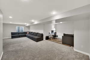 Carpeted living area with an office area and recessed lighting