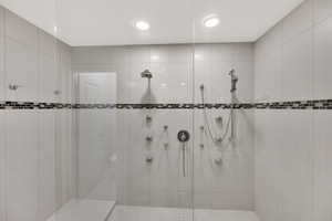 Full bathroom with a tile shower and recessed lighting