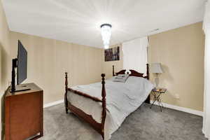 Bedroom with carpet flooring and baseboards