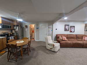 Dining space with carpet floors, a ceiling fan, and a textured ceiling