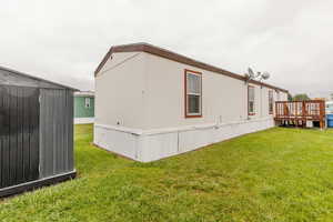 View of side of home featuring a lawn