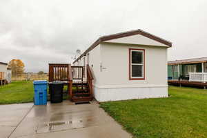 View of side of home with a wooden deck