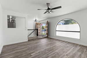 Living room with LVP floors, healthy amount of natural light, and ceiling fan
