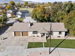 Aerial view of property and surrounding area featuring a mountain backdrop