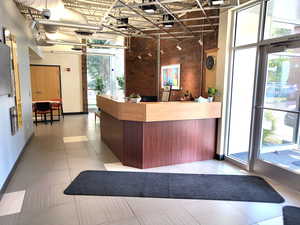 Welcome area featuring brick wall and a towering ceiling