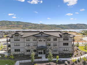 Back of property with a mountain view and stone siding