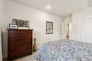 Bedroom featuring baseboards and light carpet