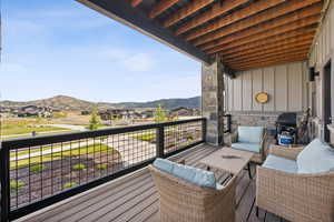 Balcony featuring area for grilling, an outdoor hangout area, and a mountain view