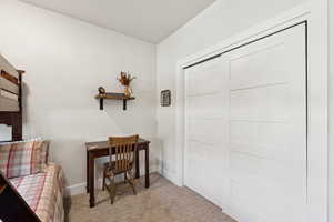 Office with baseboards and carpet