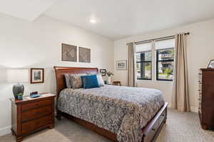Bedroom featuring light carpet and baseboards