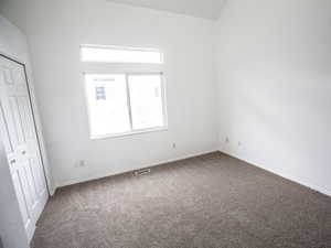 Unfurnished bedroom with carpet and a closet