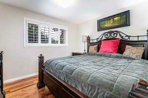 Bedroom featuring light wood finished floors and baseboards
