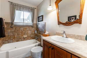 Full bath with a garden tub and vanity