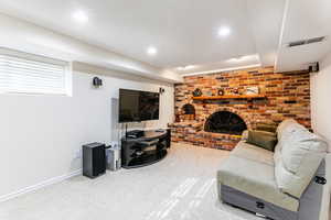 Living area with a fireplace, carpet flooring, and recessed lighting