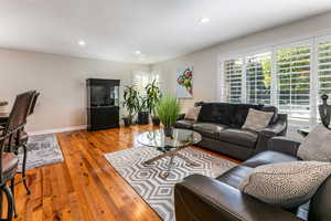 Living room with recessed lighting and wood-type flooring