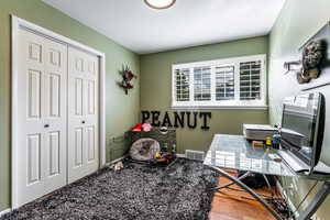 Office space with light wood-style flooring and baseboards