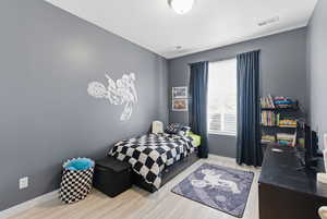 Bedroom featuring light wood-style flooring and baseboards