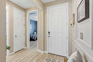 Entrance foyer featuring wood finished floors and baseboards