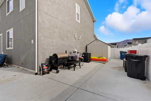 Fenced backyard with a storage unit, area for grilling, and a mountain view