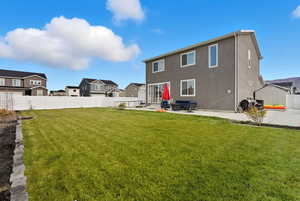 Back of house with a fenced backyard, a patio, a residential view, entry steps, and stucco siding