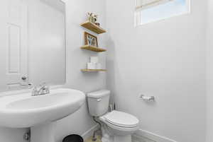 Half bathroom featuring baseboards and wood finished floors
