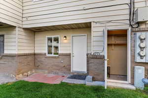 Property entrance featuring brick siding