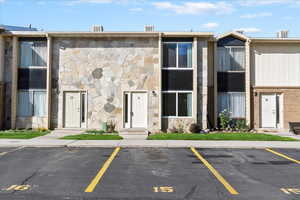 View of property featuring uncovered parking